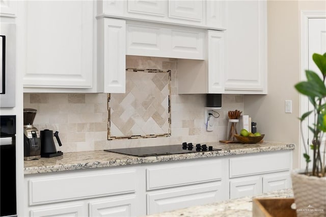 2509 Mcleod Ave, Edinburg, TX 78539 - kitchen featuring white cabinetry, black electric cooktop, tasteful backsplash, and wall oven