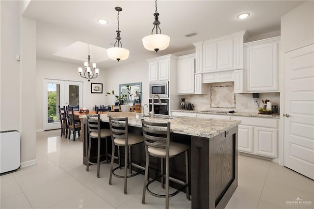 2509 Mcleod Ave, Edinburg, TX 78539 - kitchen with appliances with stainless steel finishes, tasteful backsplash, recessed lighting, light tile patterned flooring, and a kitchen bar
