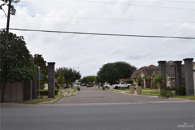 2707 Live Oak St, Mission, TX 78574 - view of asphalt street featuring sidewalks, curbs, and street lights
