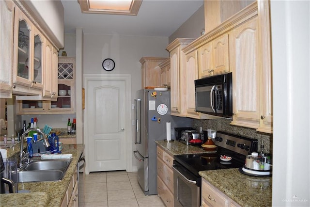 2707 Live Oak St, Mission, TX 78574 - kitchen featuring appliances with stainless steel finishes, a sink, light brown cabinetry, and glass insert cabinets