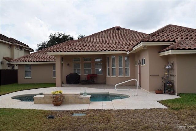 2707 Live Oak St, Mission, TX 78574 - rear view of house with a patio, stucco siding, a tiled roof, and an outdoor pool