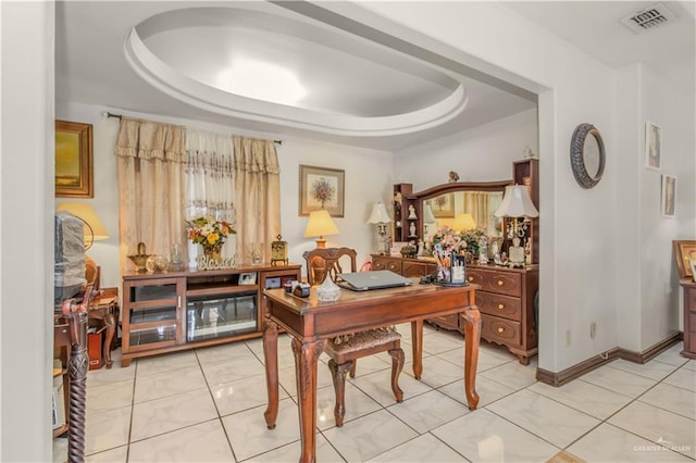 office area featuring a tray ceiling and light tile patterned floors