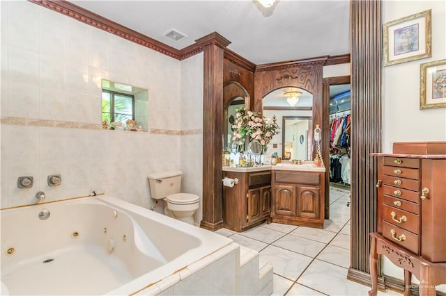 bathroom featuring tiled tub, vanity, ornamental molding, and toilet