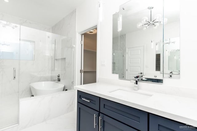 bathroom with vanity, shower with separate bathtub, and an inviting chandelier