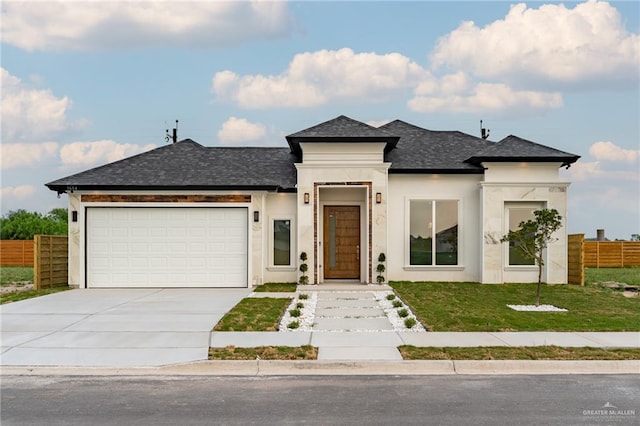 view of front facade with a garage and a front lawn