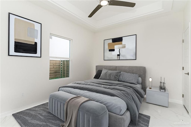 bedroom featuring a tray ceiling and ceiling fan