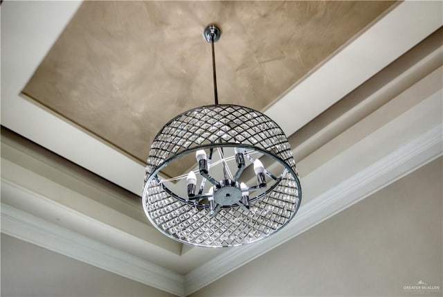 details featuring a tray ceiling and crown molding