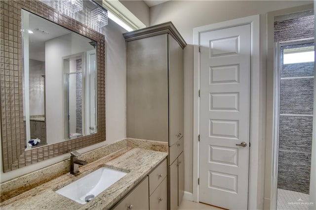 bathroom with vanity and a shower with shower door