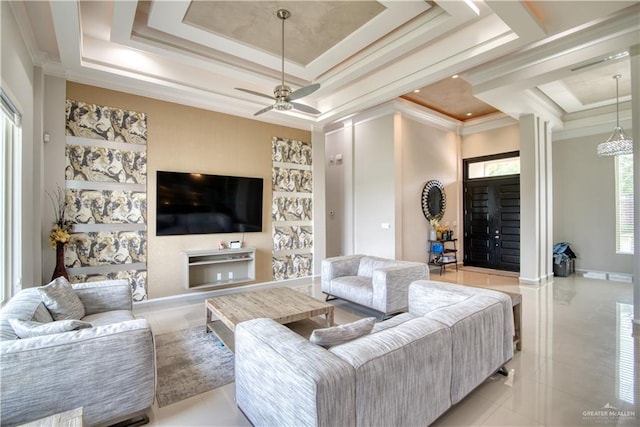 living room featuring ceiling fan, a raised ceiling, light tile patterned floors, and crown molding