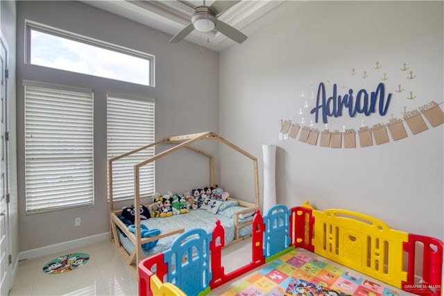 tiled bedroom featuring ceiling fan