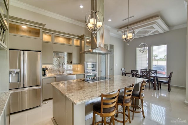 kitchen with pendant lighting, sink, appliances with stainless steel finishes, a notable chandelier, and light stone counters