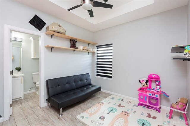 rec room featuring light wood-type flooring and ceiling fan