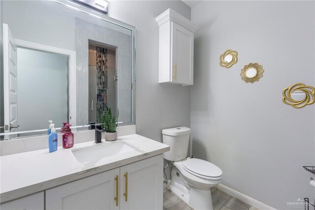 bathroom featuring hardwood / wood-style floors, vanity, and toilet