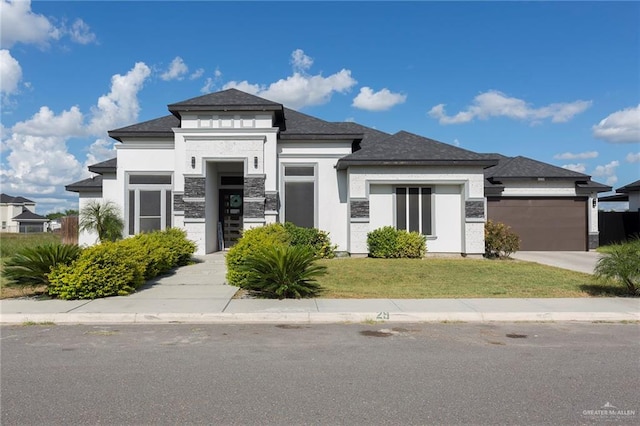 view of front of property with a garage and a front yard