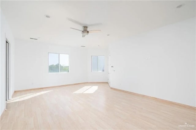 empty room with light wood-type flooring and ceiling fan