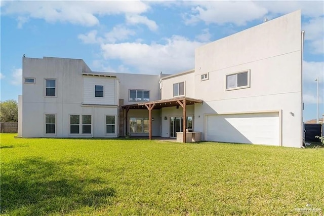 rear view of property with a garage and a yard