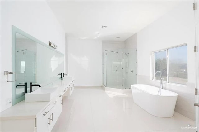 bathroom with shower with separate bathtub, vanity, and tile patterned floors