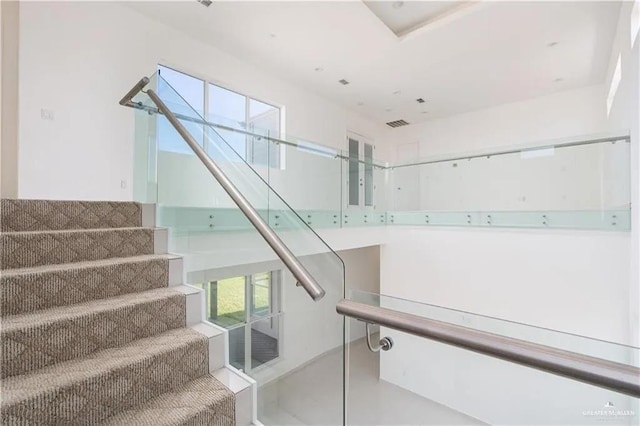 staircase with a wealth of natural light