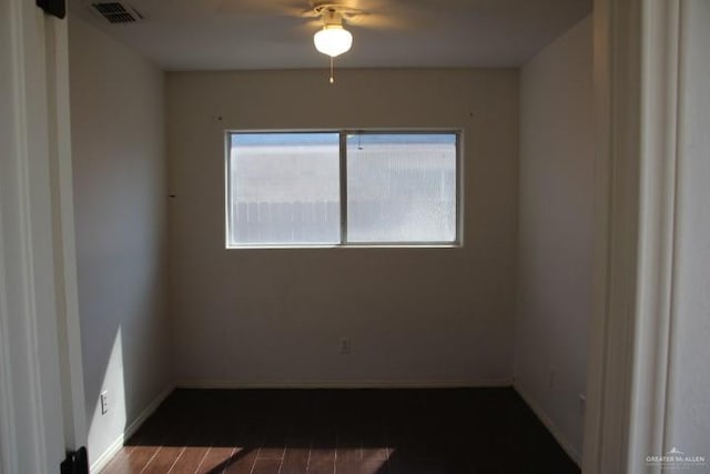 spare room featuring wood-type flooring