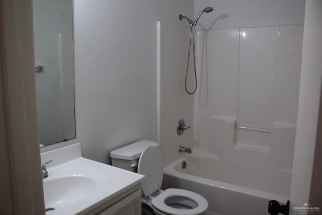 full bathroom featuring washtub / shower combination, vanity, and toilet