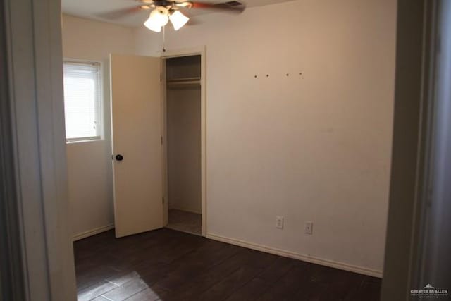 unfurnished bedroom featuring a closet, ceiling fan, and dark wood-type flooring