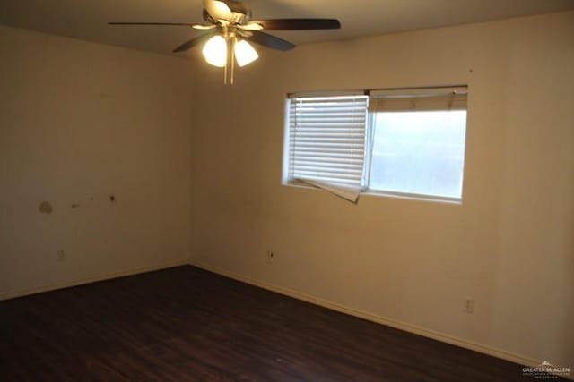 empty room featuring ceiling fan and dark wood-type flooring