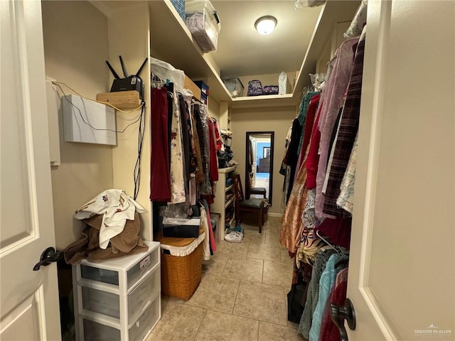 spacious closet with light tile patterned floors