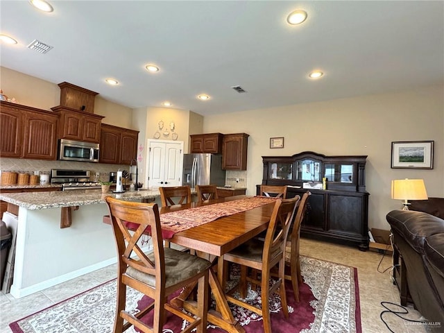 tiled dining room featuring sink