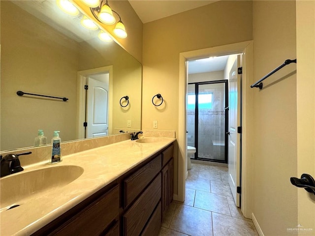 bathroom featuring an enclosed shower, vanity, toilet, and tile patterned floors