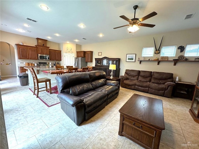 tiled living room featuring ceiling fan