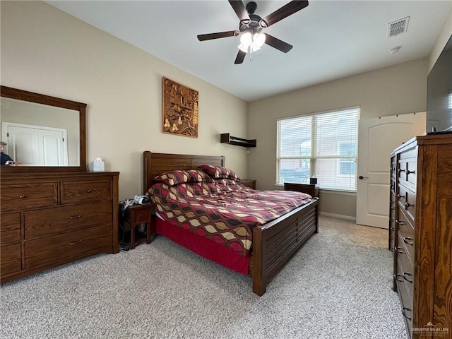 bedroom with ceiling fan and light carpet