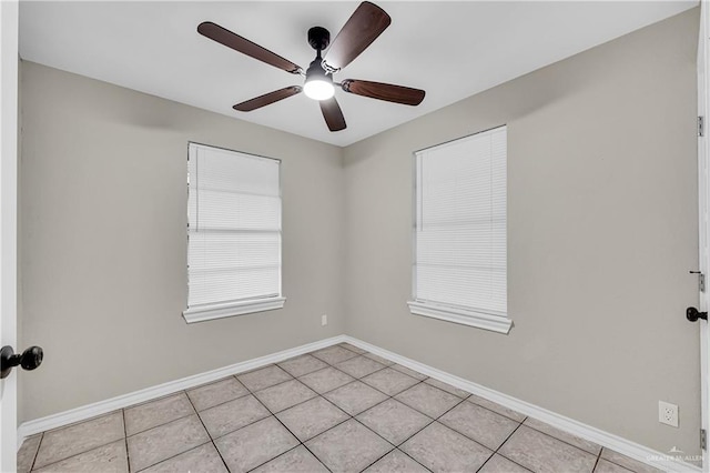 unfurnished room with ceiling fan and light tile patterned floors