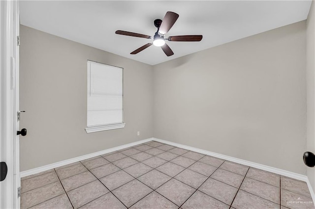 empty room with ceiling fan and light tile patterned floors