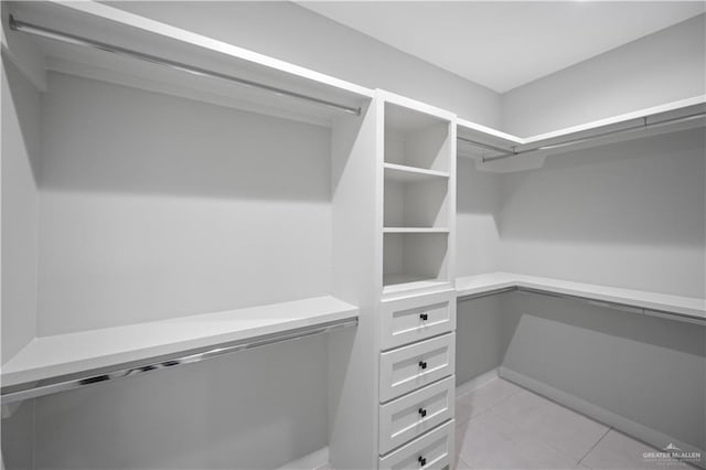 spacious closet featuring light tile patterned floors