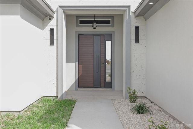 doorway to property with stucco siding