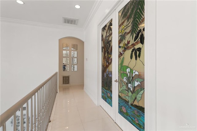 corridor with arched walkways, visible vents, ornamental molding, and recessed lighting