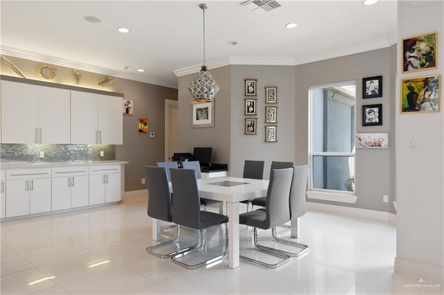 dining area with visible vents, baseboards, crown molding, and light tile patterned floors
