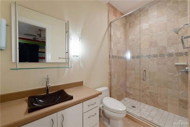 full bath featuring vanity, toilet, a ceiling fan, and a stall shower