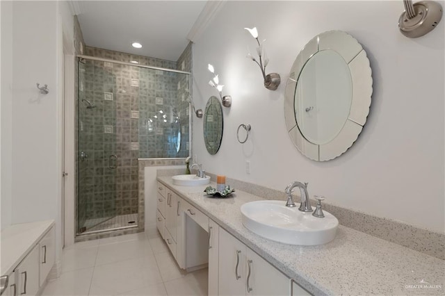 bathroom featuring double vanity, a sink, tile patterned floors, and a stall shower