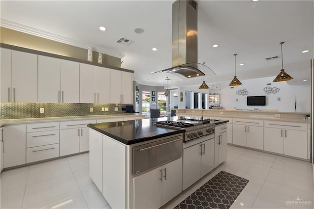 kitchen with island exhaust hood, visible vents, a center island, stainless steel gas cooktop, and a warming drawer