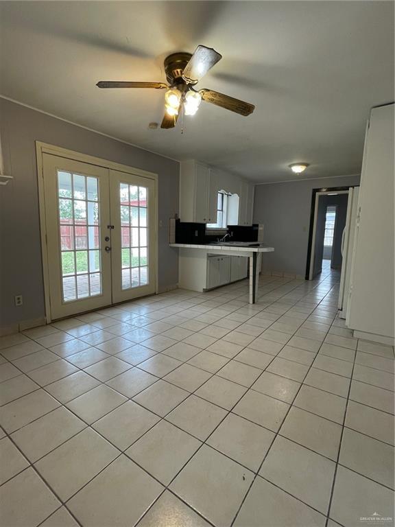 kitchen with french doors, light tile patterned flooring, a ceiling fan, and white cabinets