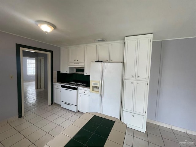 kitchen featuring light tile patterned floors, white appliances, visible vents, and white cabinetry