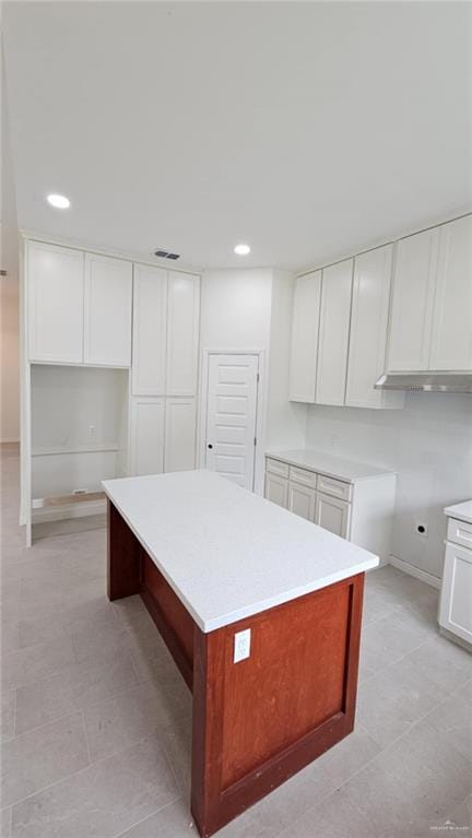 406 Zapata St, San Juan, TX 78589 - kitchen featuring a center island, recessed lighting, white cabinets, and light countertops