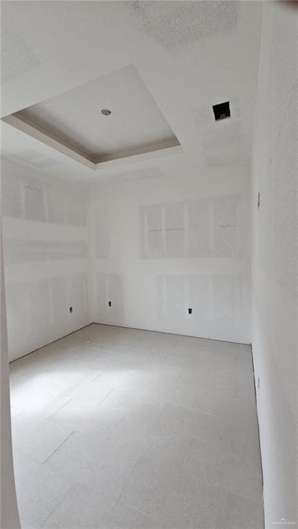 empty room with a raised ceiling