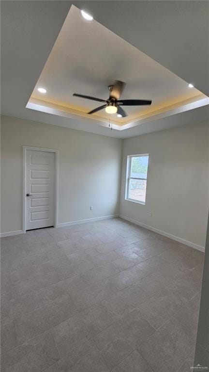 406 Zapata St, San Juan, TX 78589 - spare room featuring a tray ceiling, recessed lighting, a ceiling fan, and baseboards