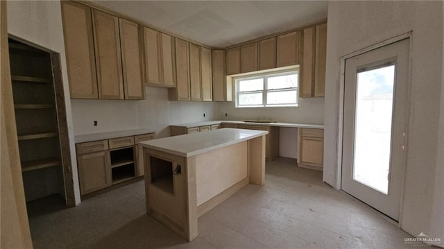 kitchen with a center island and light brown cabinets