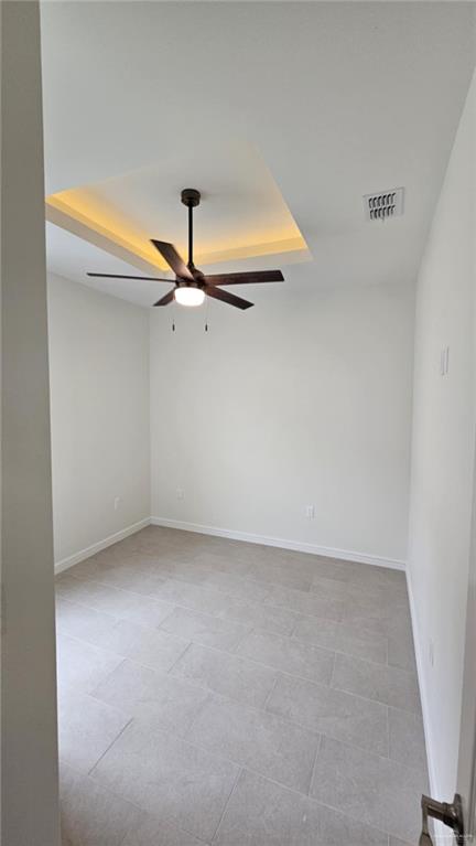 406 Zapata St, San Juan, TX 78589 - empty room featuring ceiling fan, baseboards, and a raised ceiling