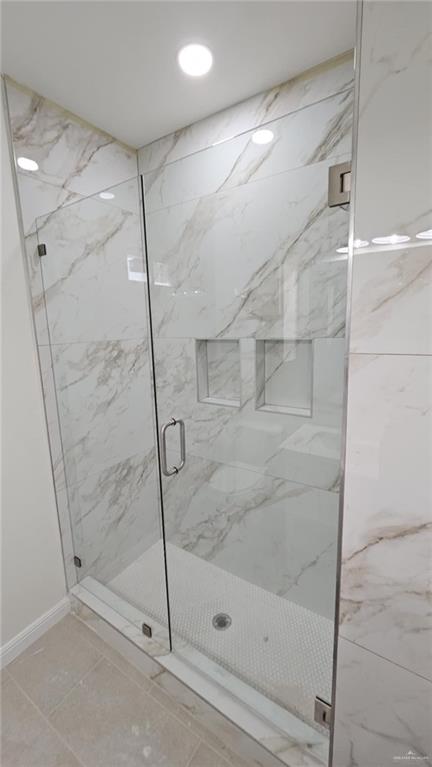 406 Zapata St, San Juan, TX 78589 - full bath with a marble finish shower and baseboards