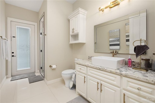 bathroom featuring vanity, tile patterned floors, and toilet