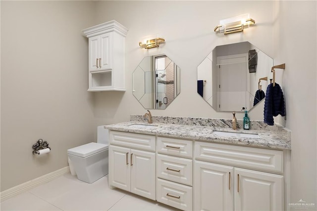 bathroom featuring vanity, tile patterned flooring, and toilet